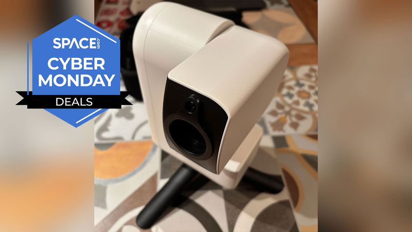 A white motorized telescope sits on a black stand with a tiled floor in the background and the space.com logo in the top left.