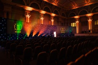 An empty awards hall at Bristol Harbour Hotel with a stage and lighting ready for the