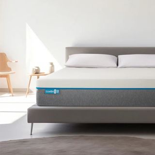 A render of the Simba Hybrid Original mattress on a grey upholstered bed in a bedroom