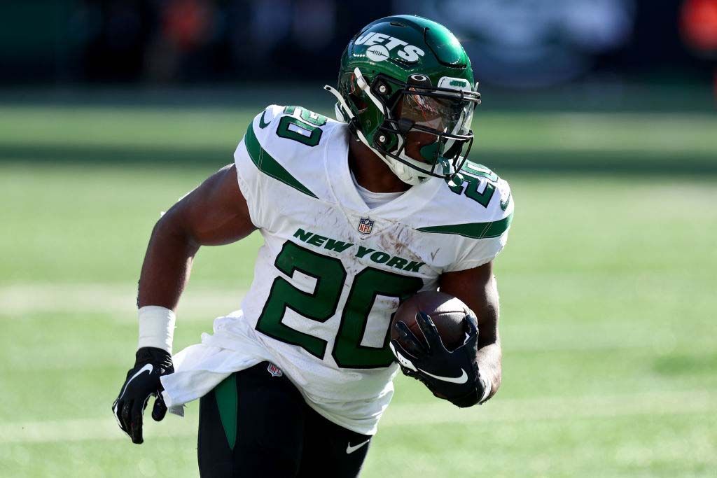 Breece Hall #20 of the New York Jets runs against the Miami Dolphins during the fourth quarter at MetLife Stadium on October 09, 2022 in East Rutherford, New Jersey.