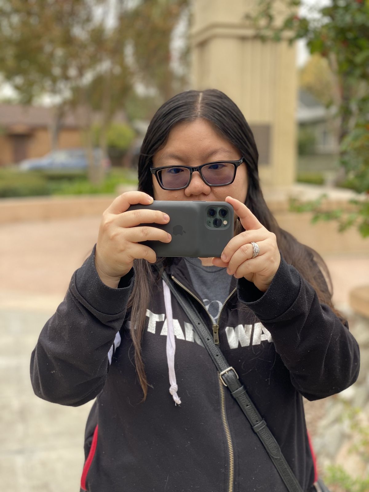 Christine takes a photo with the Smart Battery Case camera button
