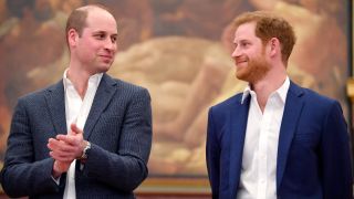 From left to right: Prince William and Prince Harry looking at each other. 