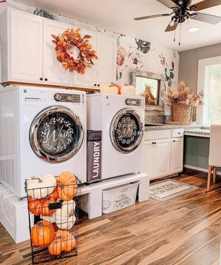 Autumnal fall themed mudroom laundry room idea with pumpkins and leafy decor