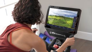 Perosn looking at the screen of the Bowflex VeloCore Bike