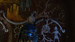 God of War Ragnarok's Kratos looks up at a painted shrine