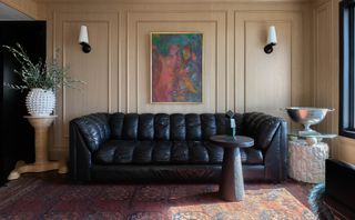 A large artwork above the sofa
