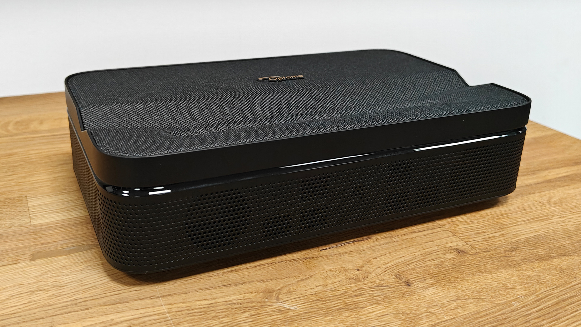 Optoma Photon Go portable UST projector on wooden surface slight angle