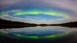 arc of green light over lake