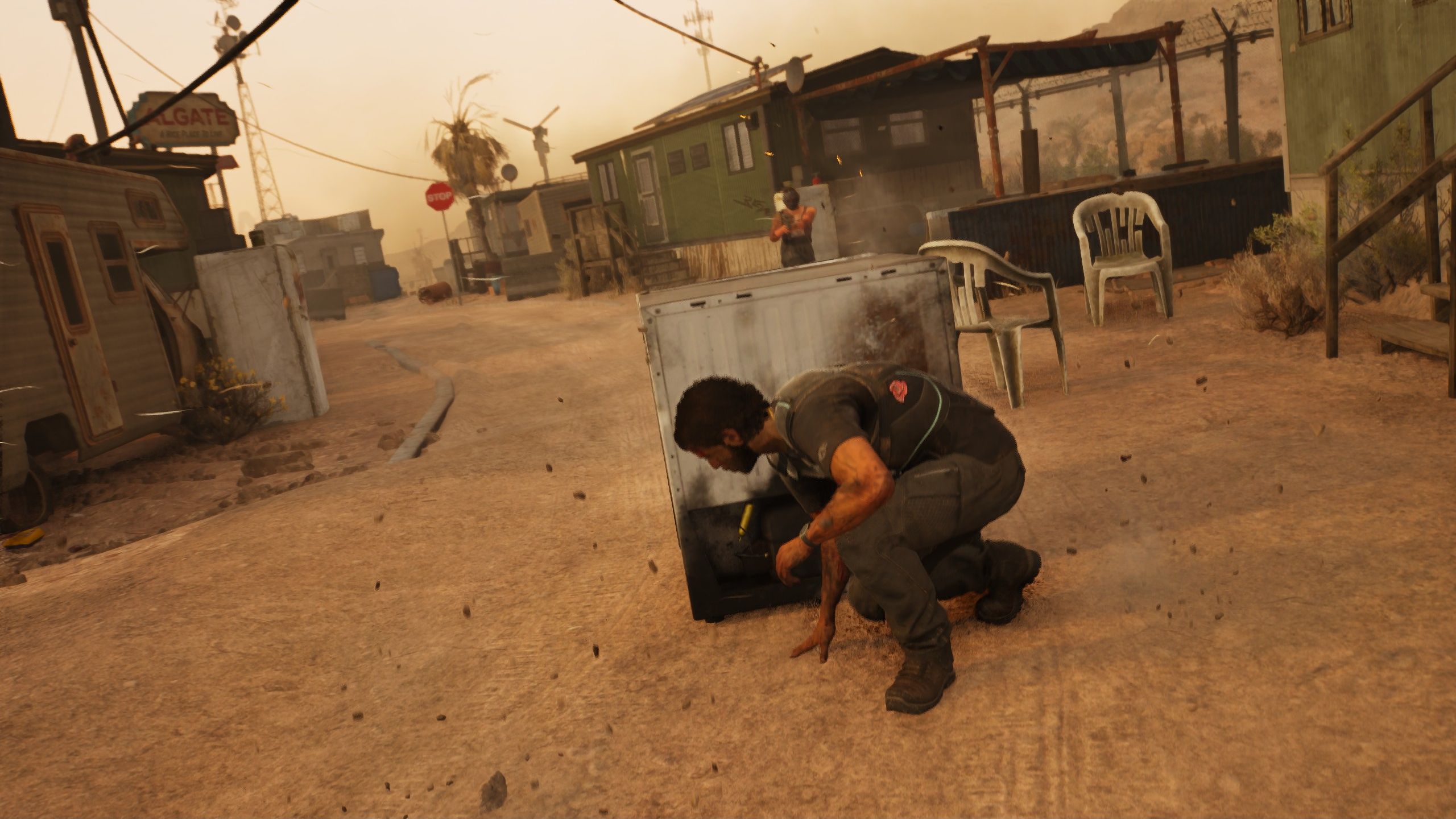 Jacob takes cover in a trailer park while someone standing in the open shoots at him