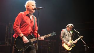 The Offspring — Dexter Holland (left) and Noodles Wasserman — perform onstage with guitars