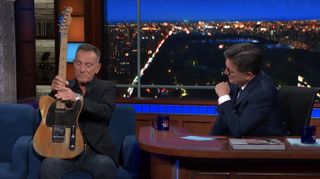 Bruce Springsteen (left) shows his Fender "mutt" to Stephen Colbert