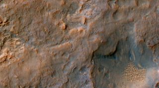 Two parallel tracks left by the wheels of NASA's Curiosity Mars rover cross rugged ground in this portion of a Dec. 11, 2013, observation by the High Resolution Imaging Science Experiment (HiRISE) camera on NASA's Mars Reconnaissance Orbiter. The rover it