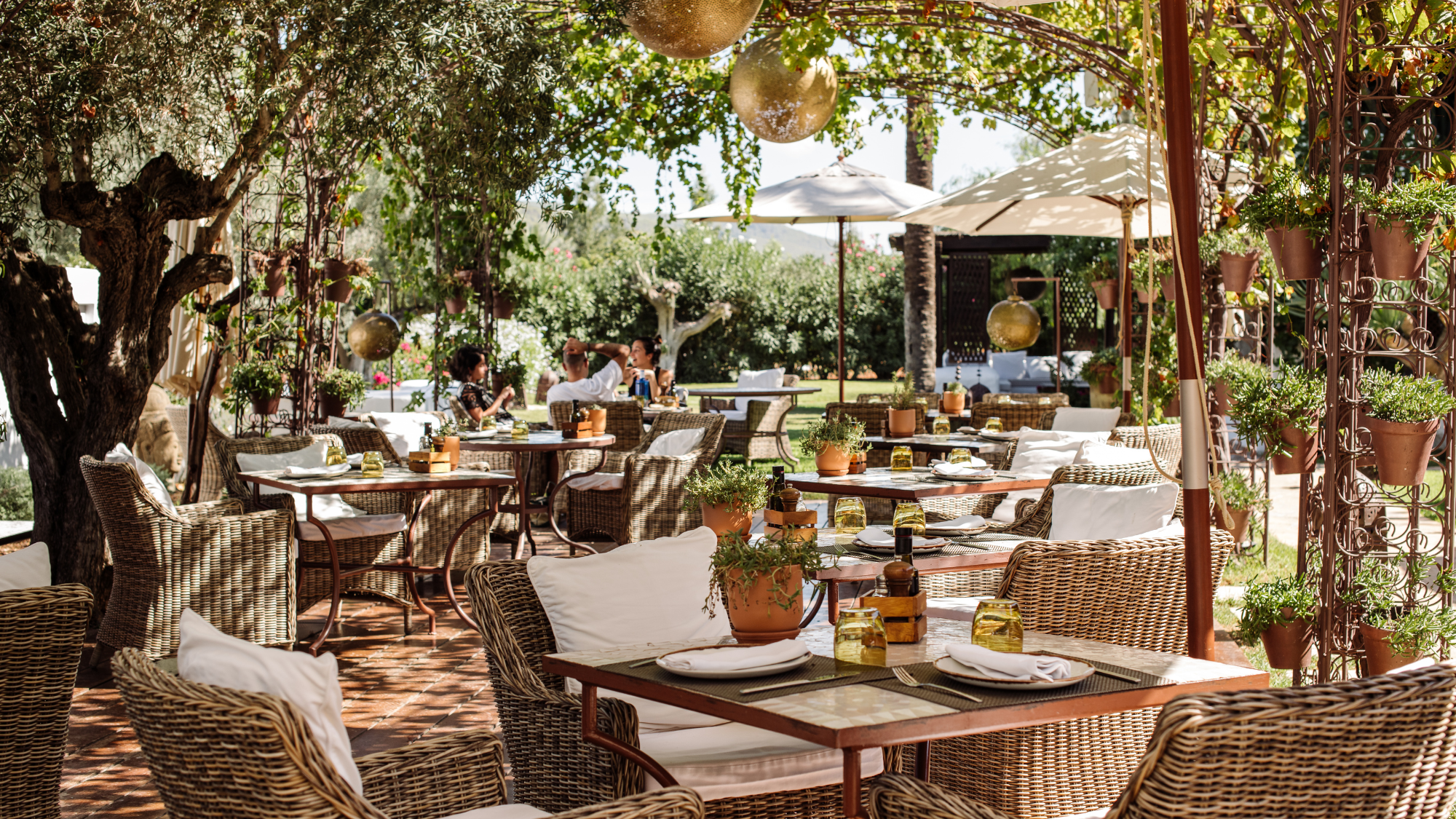 Outdoor dining tables at Atzar&amp;oacute; Agroturismo Hotel