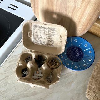 egg box being used to store screws, elastic bands and other loose items