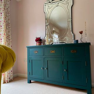 painted cabinet in green and pink wall