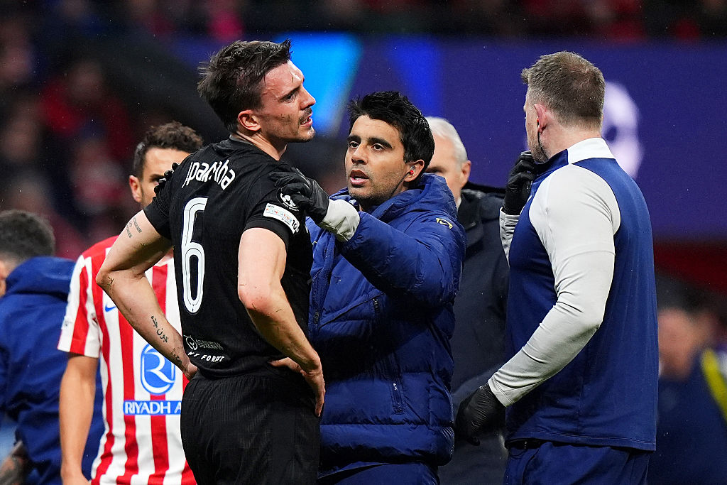 Joao Palhinha receives treatment after clashing heads with teammate Cristian Romero