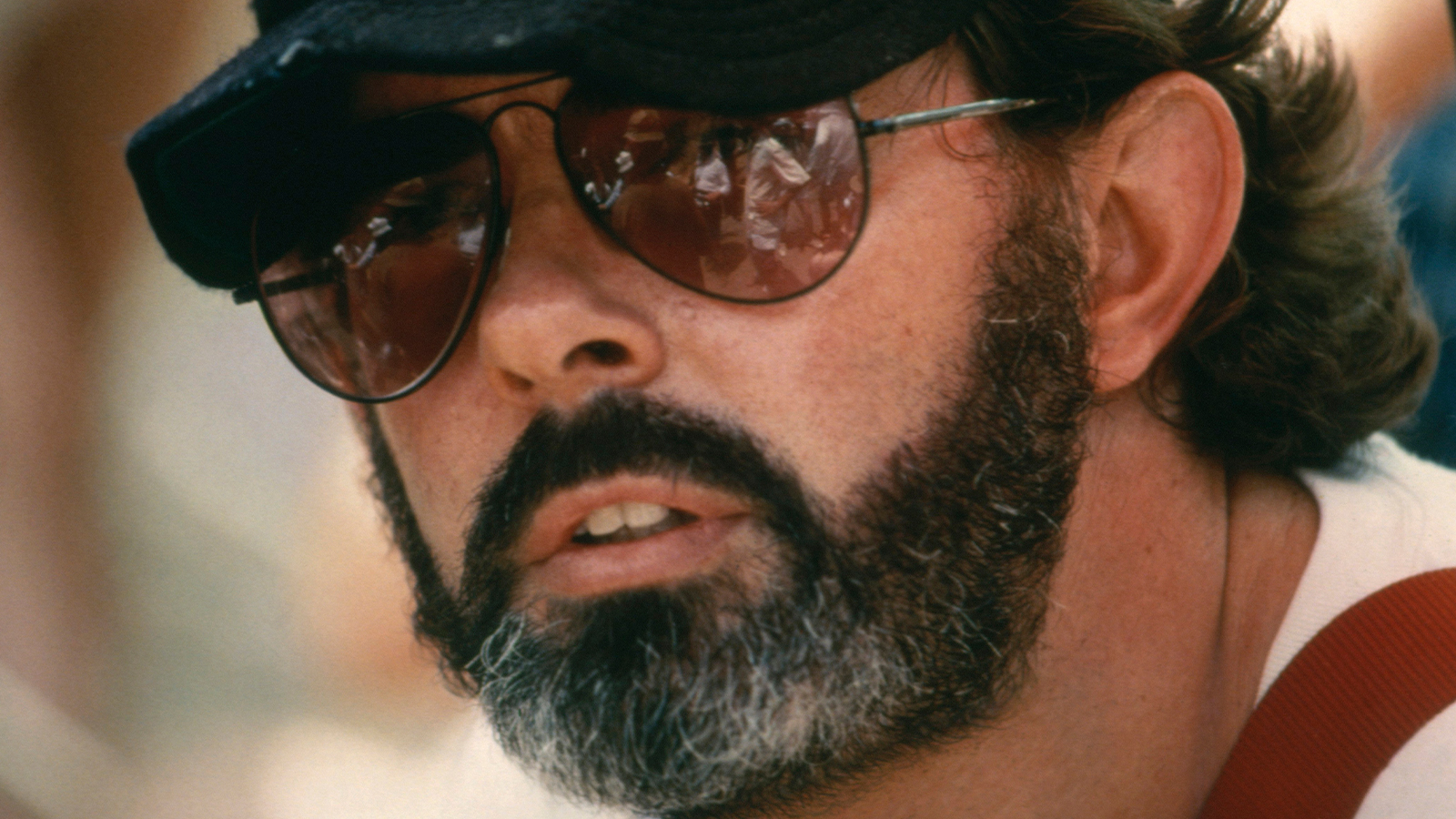 A photo of George Lucas in sunglasses and a cap, from the 1970s