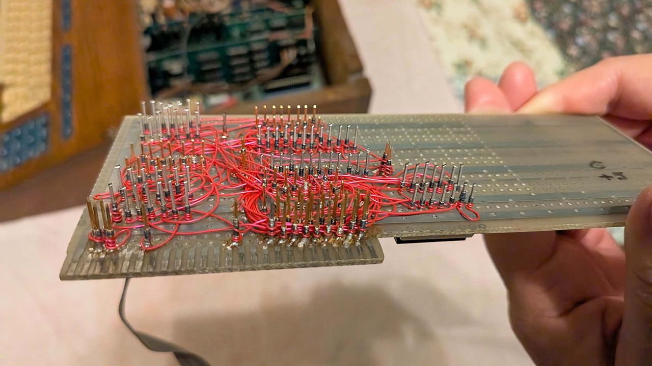 A picture of a motherboard with custom cut and jumpers.