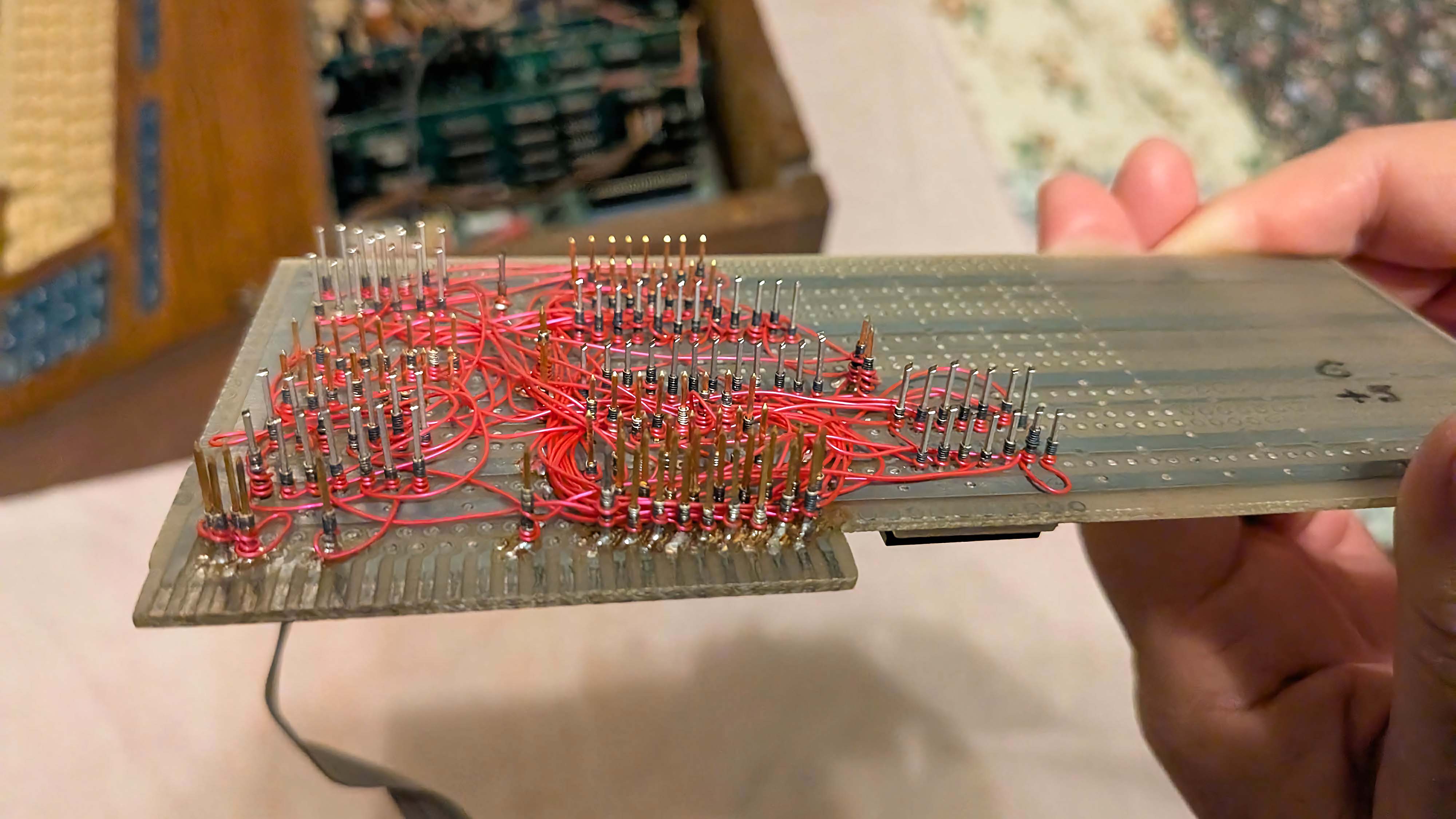 A picture of a motherboard with custom cut and jumpers.