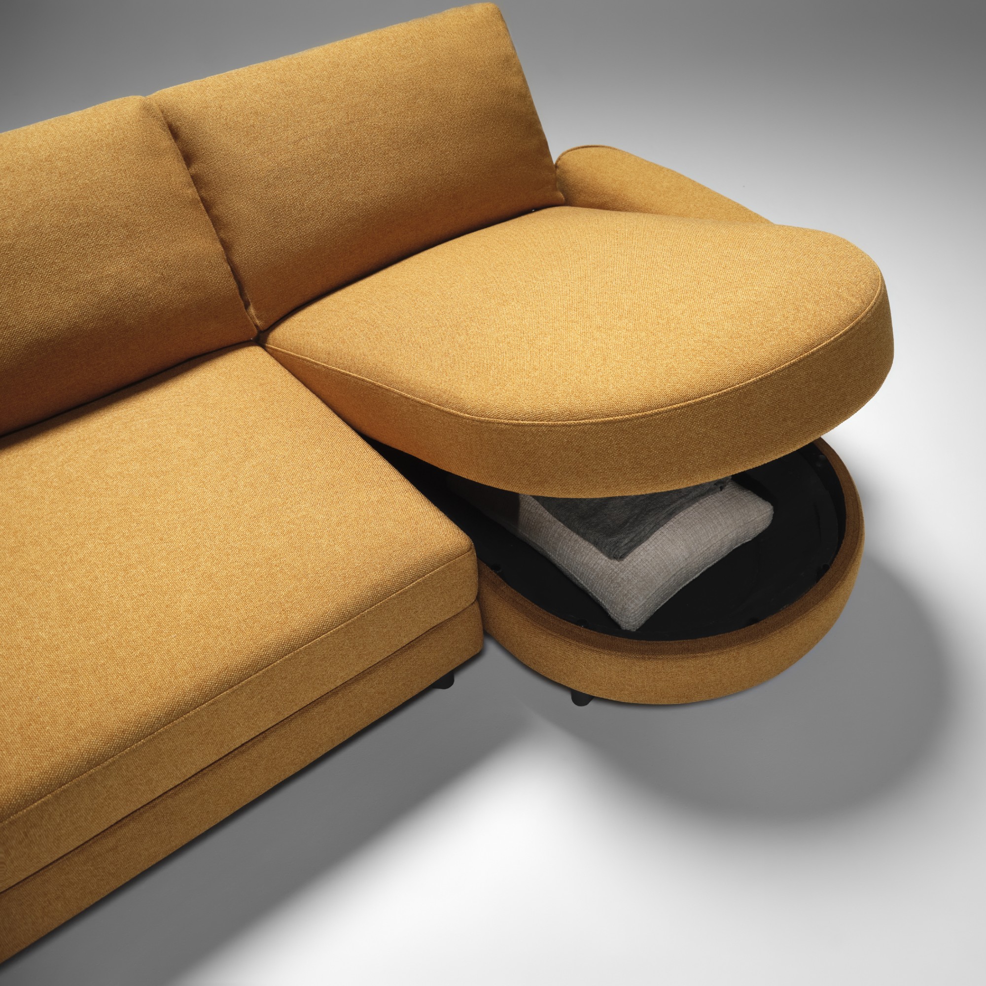 The curved King Living Delta 5 storage sofa in orange with built-in storage