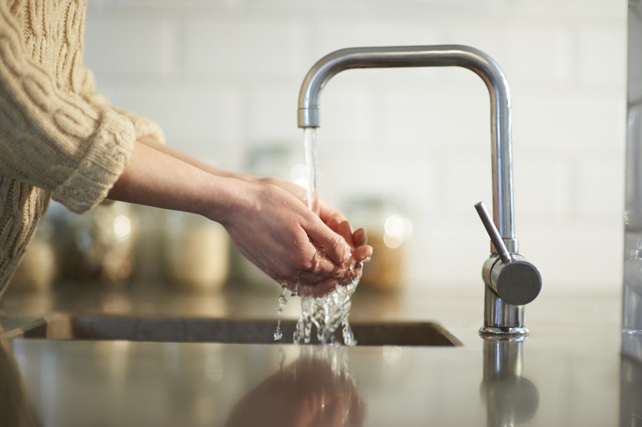 washing hands in kitchen sink