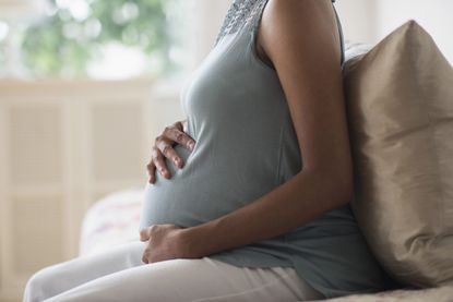 A pregnant woman experiencing Braxton Hicks contractions 