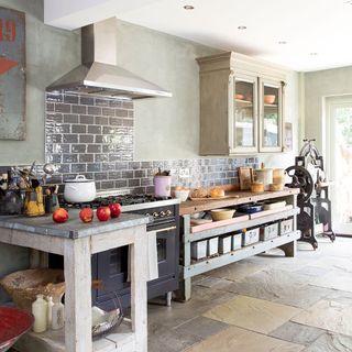 metro tiled kitchen with grey cooker and wooden cabinet