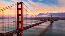 Pass under the iconic Golden Gate Bridge on a sunset cruise