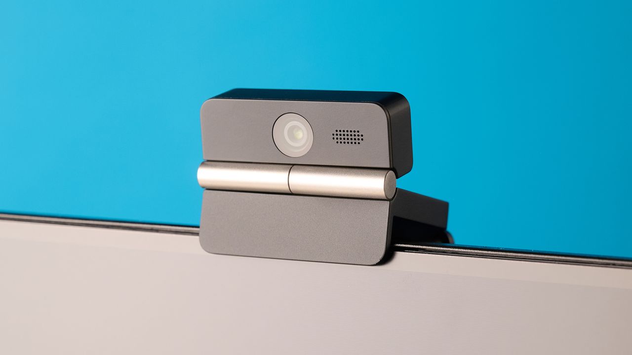 Obsbot Meet Flip foldable webcam photographed in front of a blue background