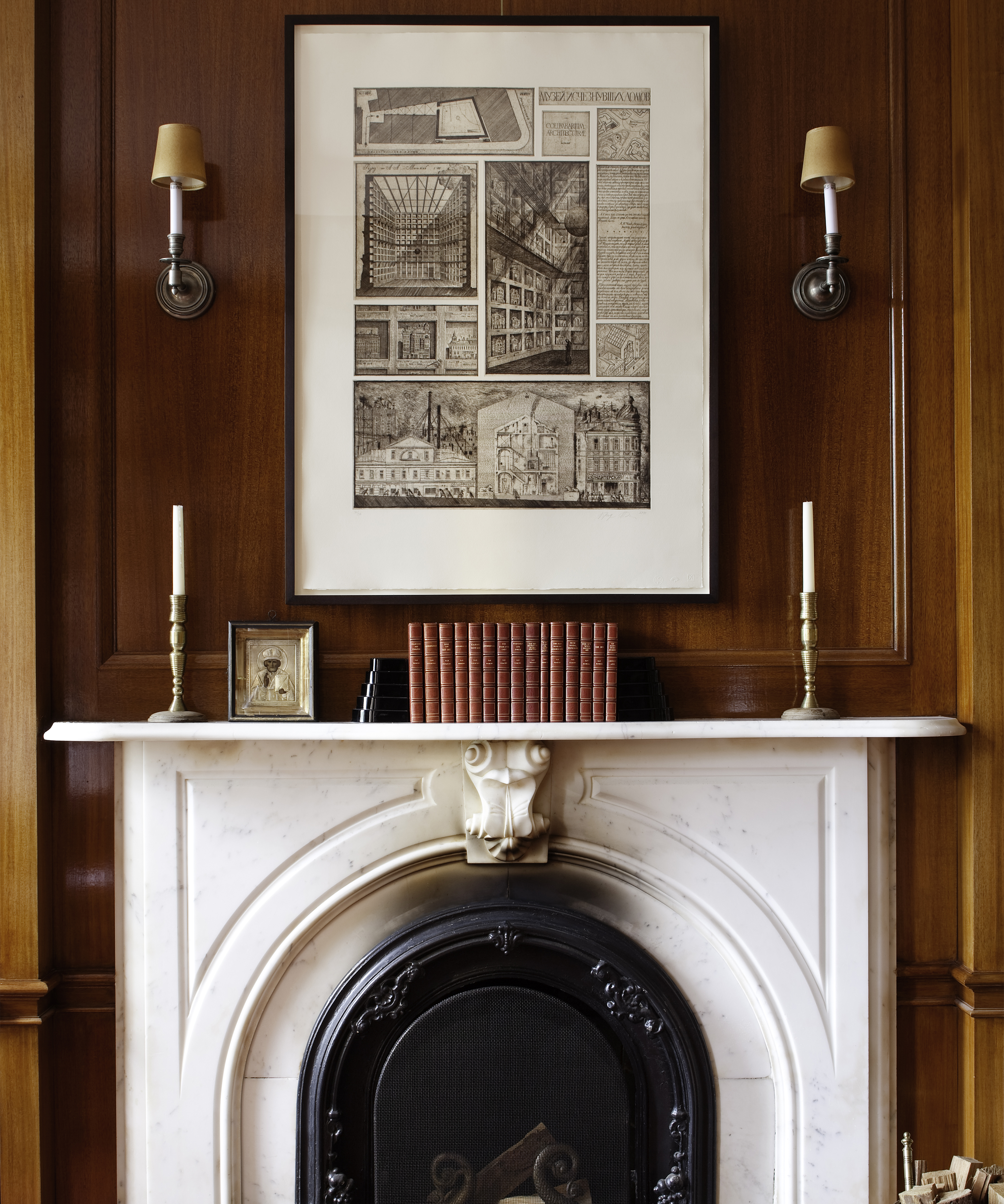 white fireplace with books and candlesticks styled on top of it