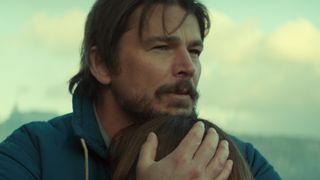 Calvin hugging his daughter in Below. 