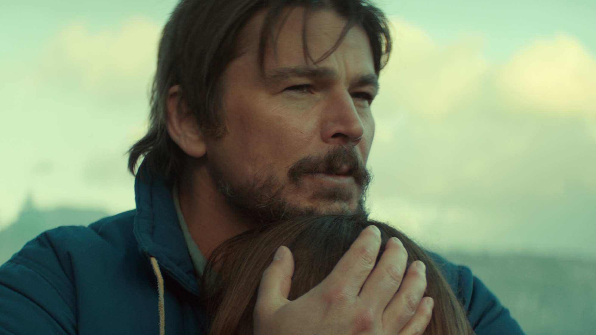 Calvin hugging his daughter in Below. 
