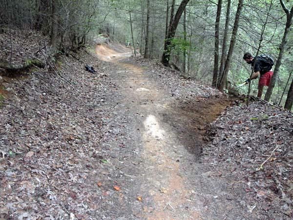 The Pisgah Race Director works on drainage.