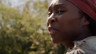 A close up of Cynthia Erivo wearing a bandana on her head in Harriet