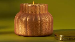 Anthropologie pumpkin spice scented candle. in gold glass jar