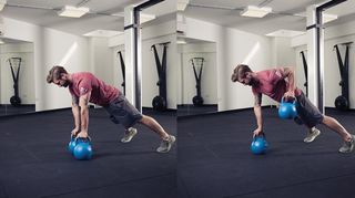 Man performs renegade row with kettlebells