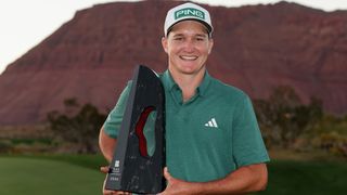 Matt McCarty holds up the 2024 Black Desert Championship trophy