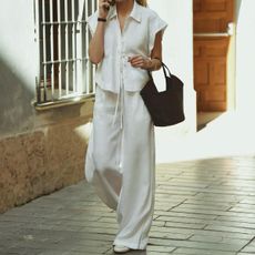 Woman in white linen pants and shirt