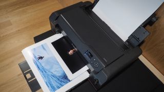 Canon ImagePrograf Pro-1100 printer in a wooden-interior studio, printing photographs