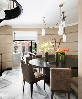 round wooden table in hallway with stairwell