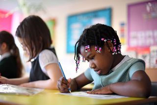 Young girl in primary school working as schools go back after lockdow