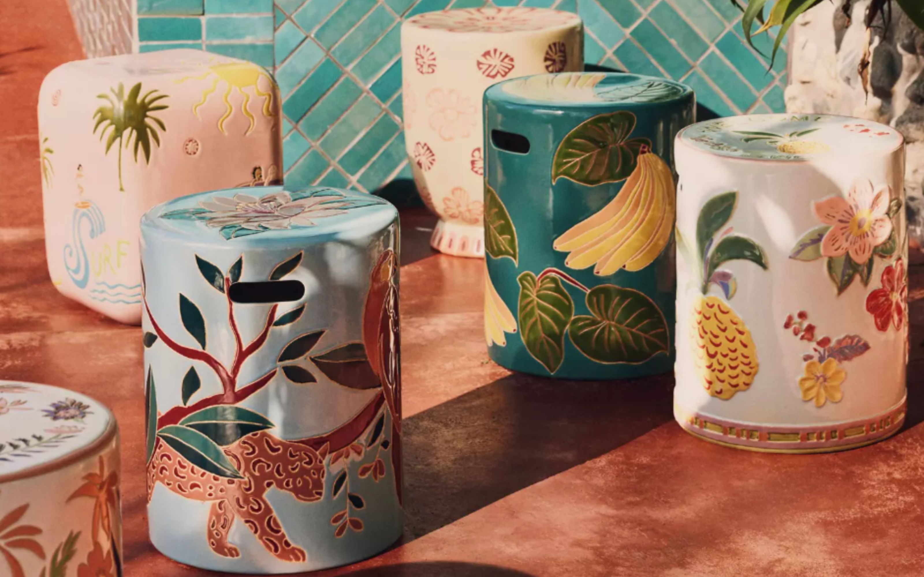 Ceramic side tables from Anthropologie with holes for carrying, in various colours and designs