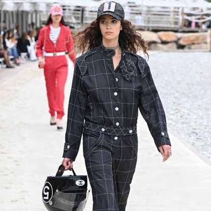 a model wearing formula 1-inspired clothes at the chanel 2023 cruise show