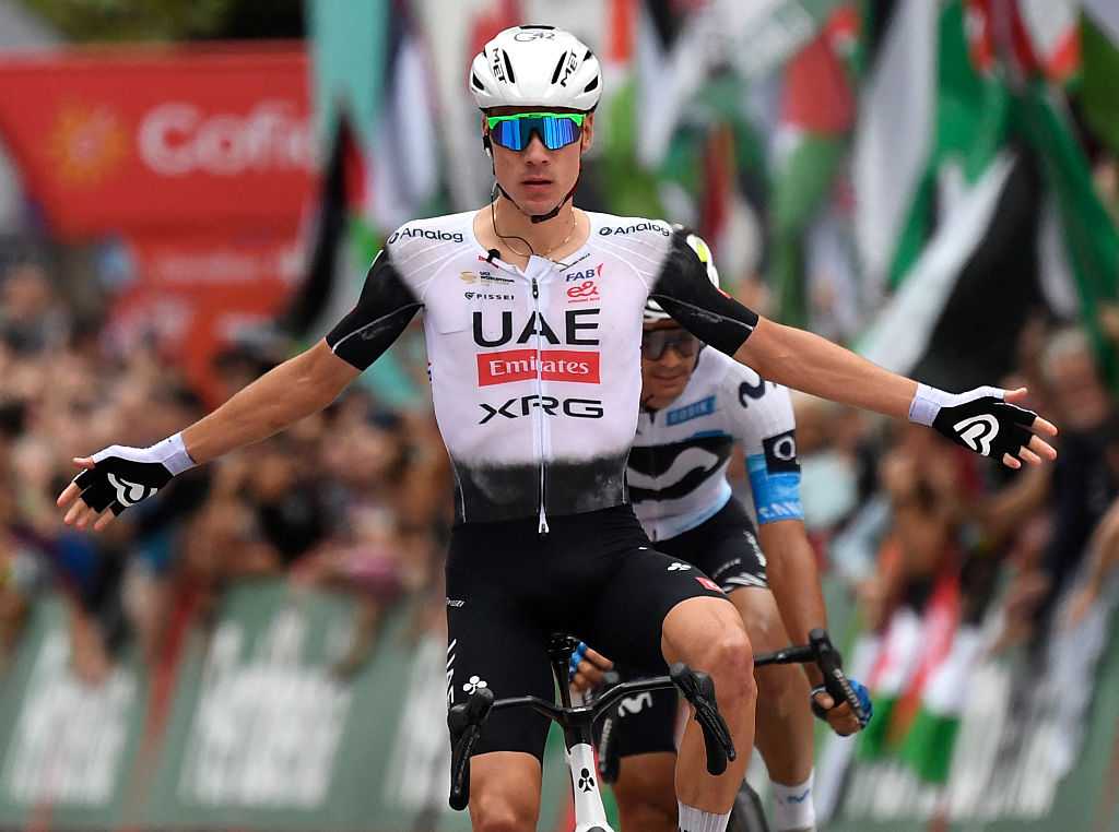 Team UAE&#039;s Spanish rider Juan Ayuso crosses the finish line to win the 12th stage of the Vuelta a Espana, a 144.9 km race between Laredo and Corrales de Buelna, on September 4, 2025. (Photo by ANDER GILLENEA / AFP)