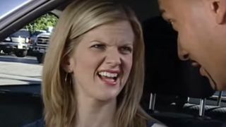 Arden Myrin nervously smiling in a car on MADtv