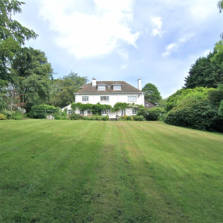 house with lawn area and white wall