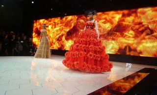 Fire on the backdrop and models wearing big red dresses