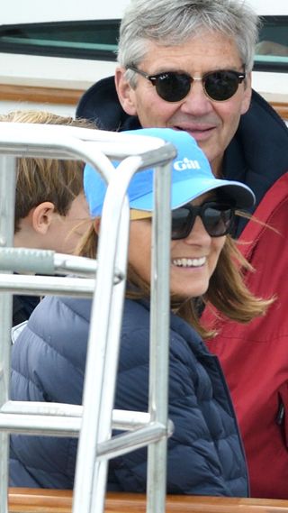 Carole Middleton wearing navy puffer coat an blue baseball cap in 2019