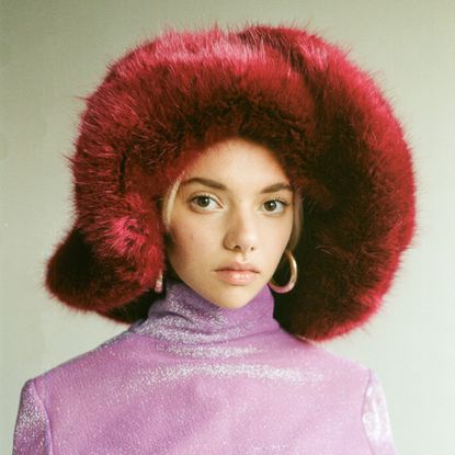 model wearing an Emma Brewin fuzzy bucket hat