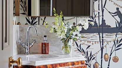 Bathroom unit surrounded by flowery wallpaper